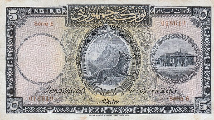 Banknote zu 5 Türkischen Lira von 1927: im Oval in der Mitte ein laufender Grauer Wolf, links die Burg von Ankara, rechts das erste Parlamentsgebäude